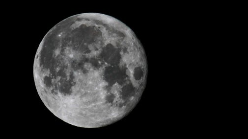 Full moon against a dark black sky.